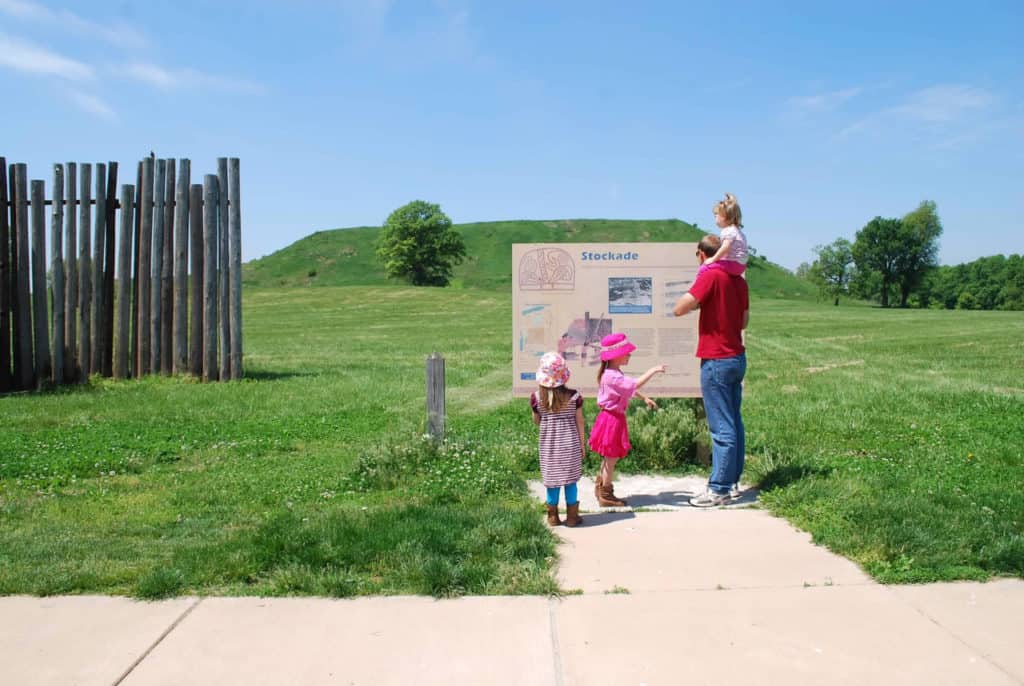 My three small daughters and I look over a display at Cahokia Mounds State Historic Site. Cahokia Mounds is one of the 37 best things to do in Southern Illinois.