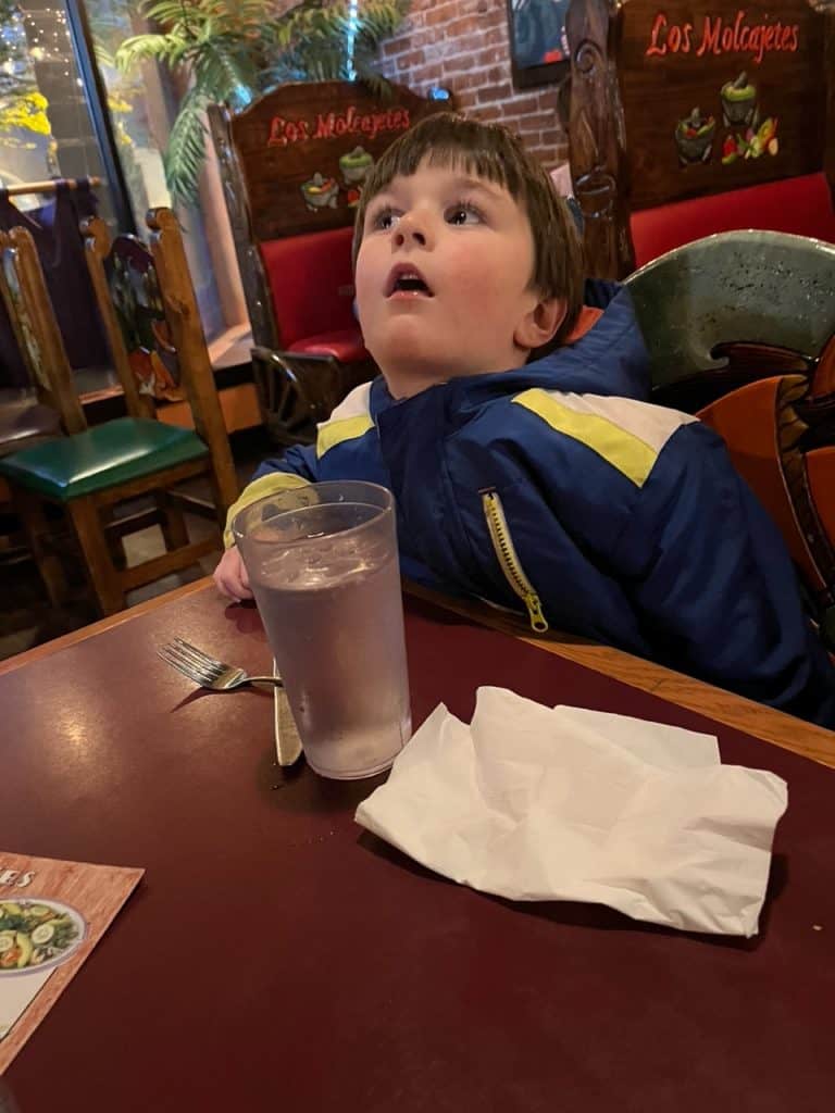 Our young son looks up astonished at all of the things on the ceiling of the restaurant where we were eating. He looks totally amazed and overwhelmed. list of national parks and monuments by state