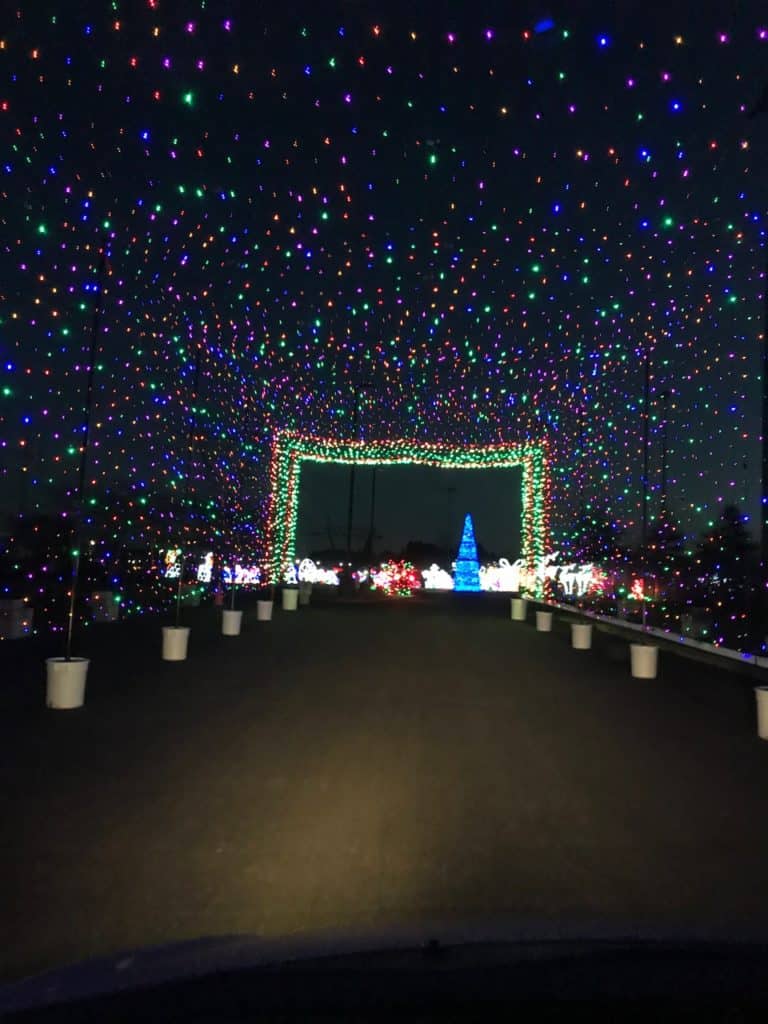 A multicolored tunnel of Christmas lights welcome visitors into Hillsboro's Lightopia display. Lightopia is one of the 9 best places to see Christmas lights in Portland.