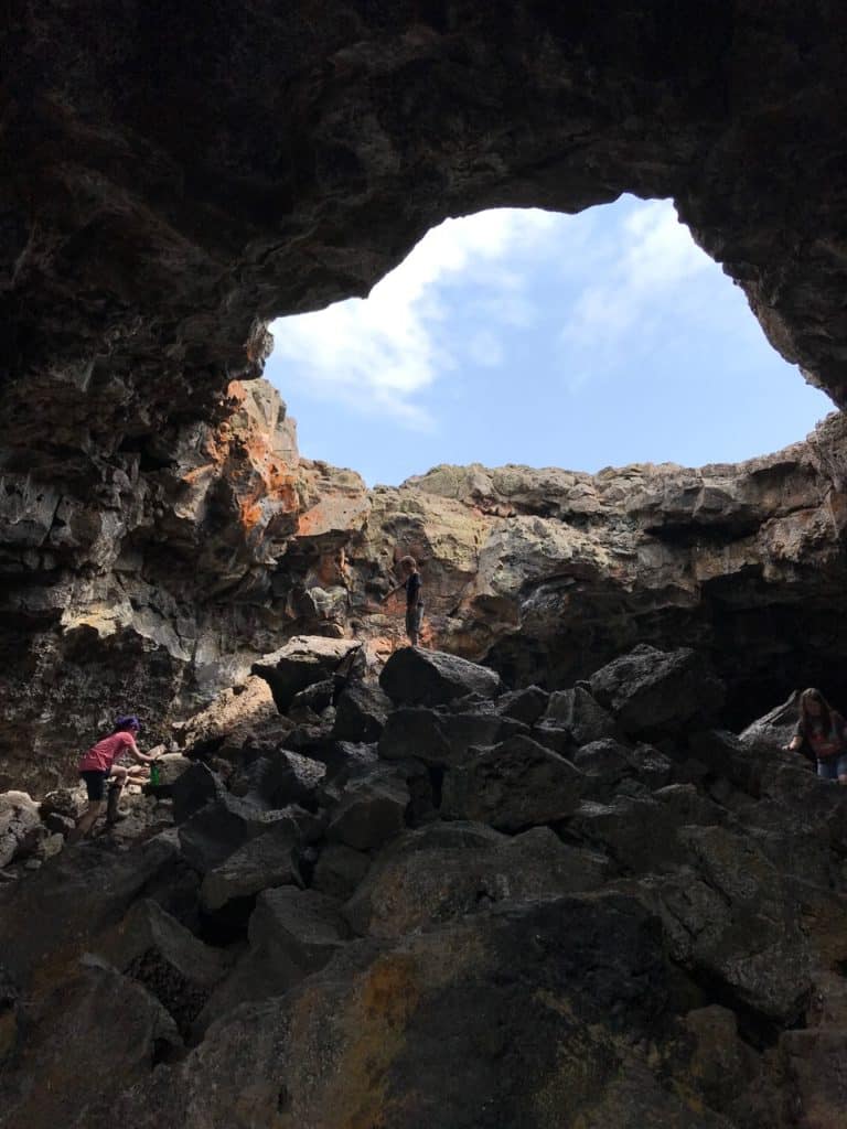 Our children explore a cave at Idaho's Craters of the Moon NM. You can find all kinds of cave parks on Dinkum Tribe's  List of National Parks and Monuments by State.