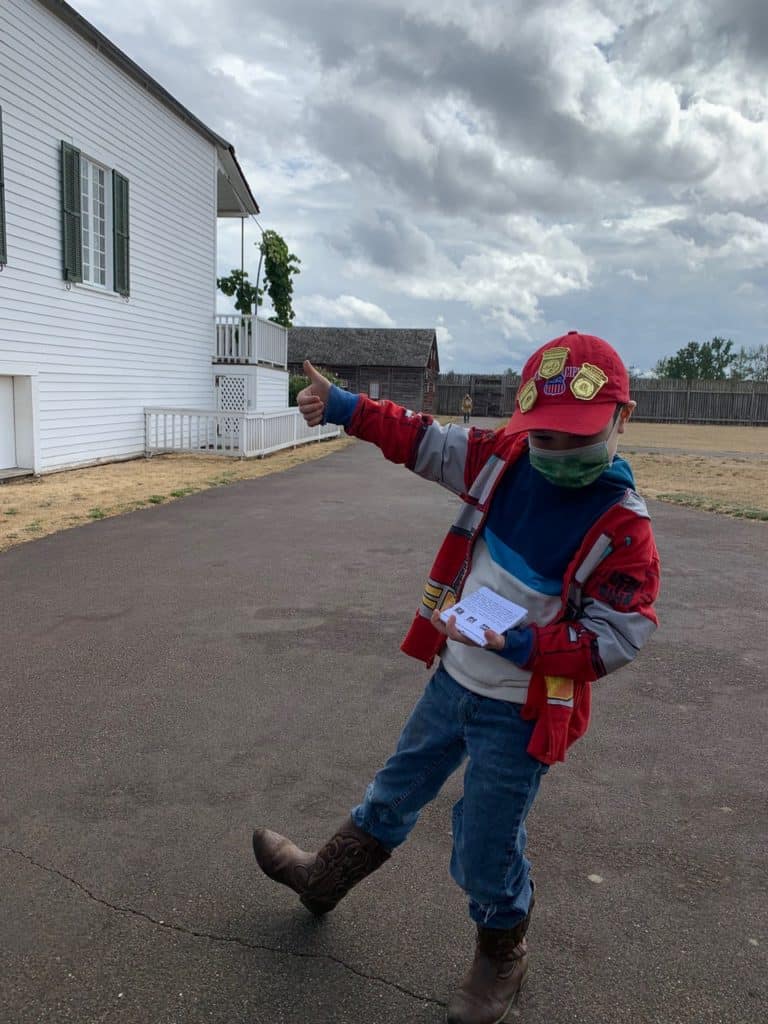 Our son gives a thumbs up while showing his hat which is covered with Jr. Ranger badges. You can find tons of educational adventures on Dinkum Tribe's list of national parks and monuments by state. 