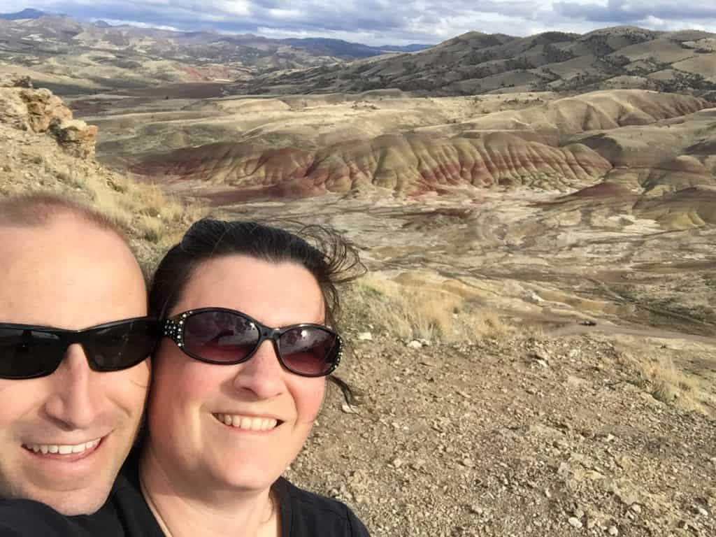 My wife smiles in a selfie at the Painted Hills in John Day Fossil Beds National Monument. John Day Fossil Beds NM is one of the best Oregon National Parks.