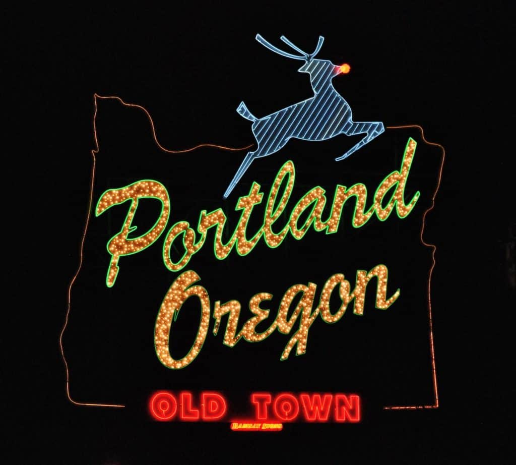 Portland's Iconic Welcome Sign glows in the cold winter night. The stag sports a red nose! Best places to see christmas lights in portland