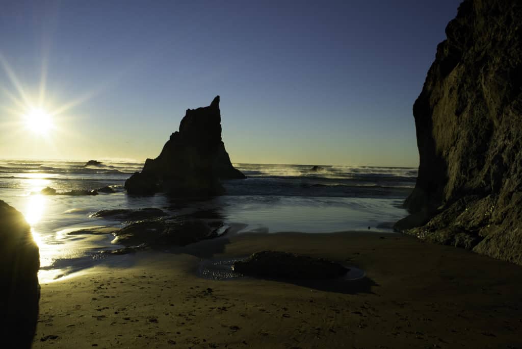 The sun makes sea stacks into beautiful silhouettes at Arcadia Beach State Recreation Site. Arcadia Beach is one of the 21 best beaches in Northern Oregon.