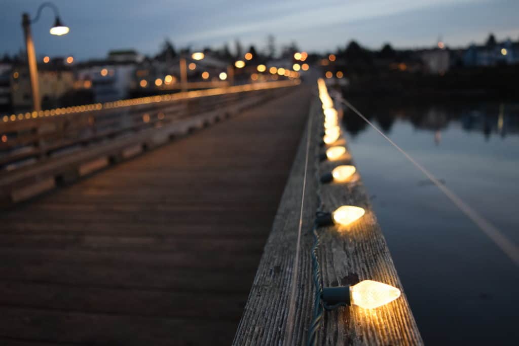Holiday lights give off a warm glow to a pier at Ebey's Landing National Historical Reserve. Ebey's Landing NHR is one of the 19 best national parks in Oregon and Washington.