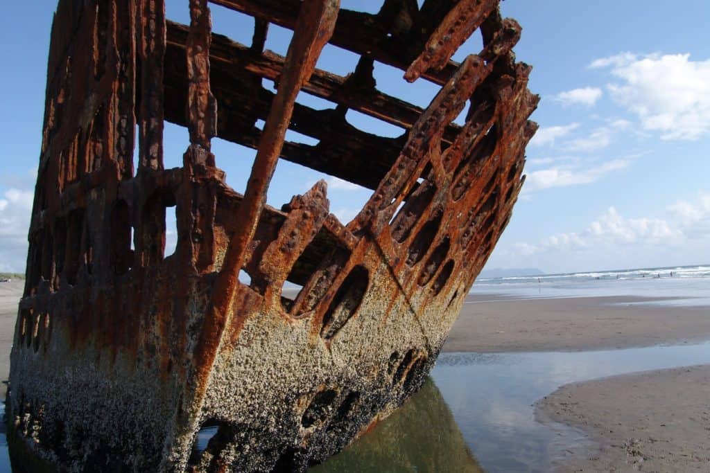 The rusting skeleton of the Peter Iredale leans silently on a Belaura Beach at Fort Stevens State Park.