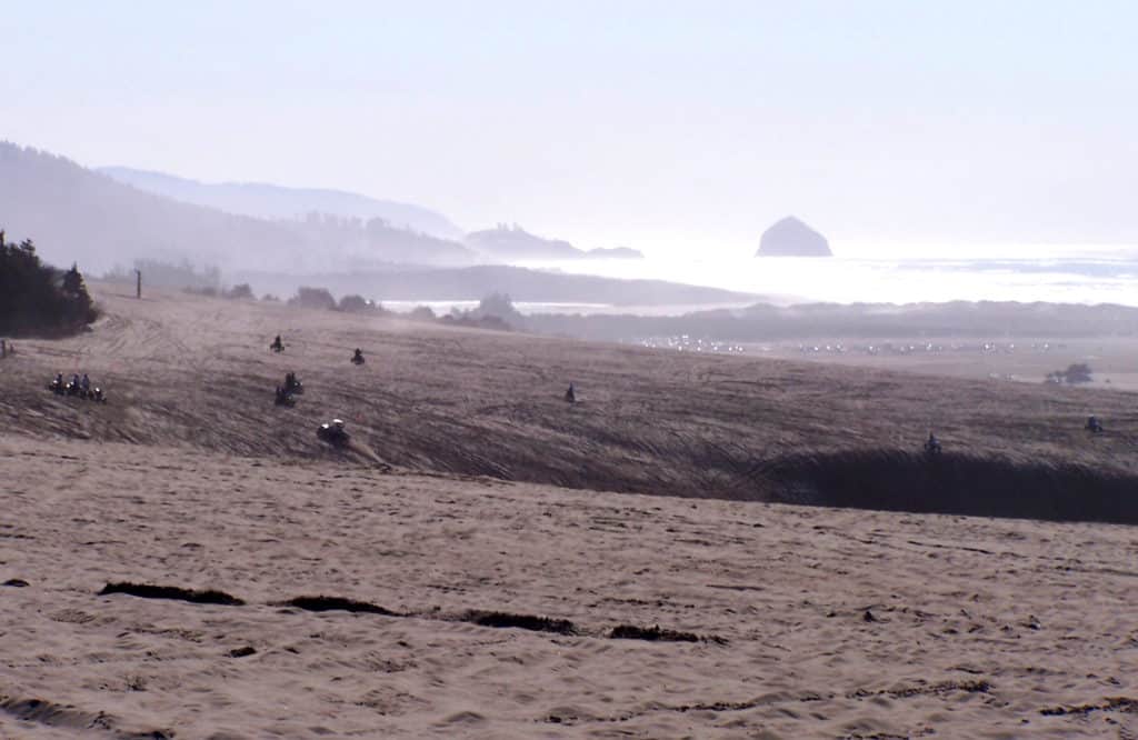 Dune buggies and ATV drive over sand dunes at Sand Lake Recreation Area.