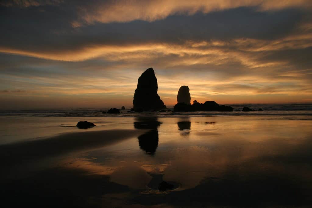 Sea stacks stand sentinel at a beautiful sunset along Cannon Beach.