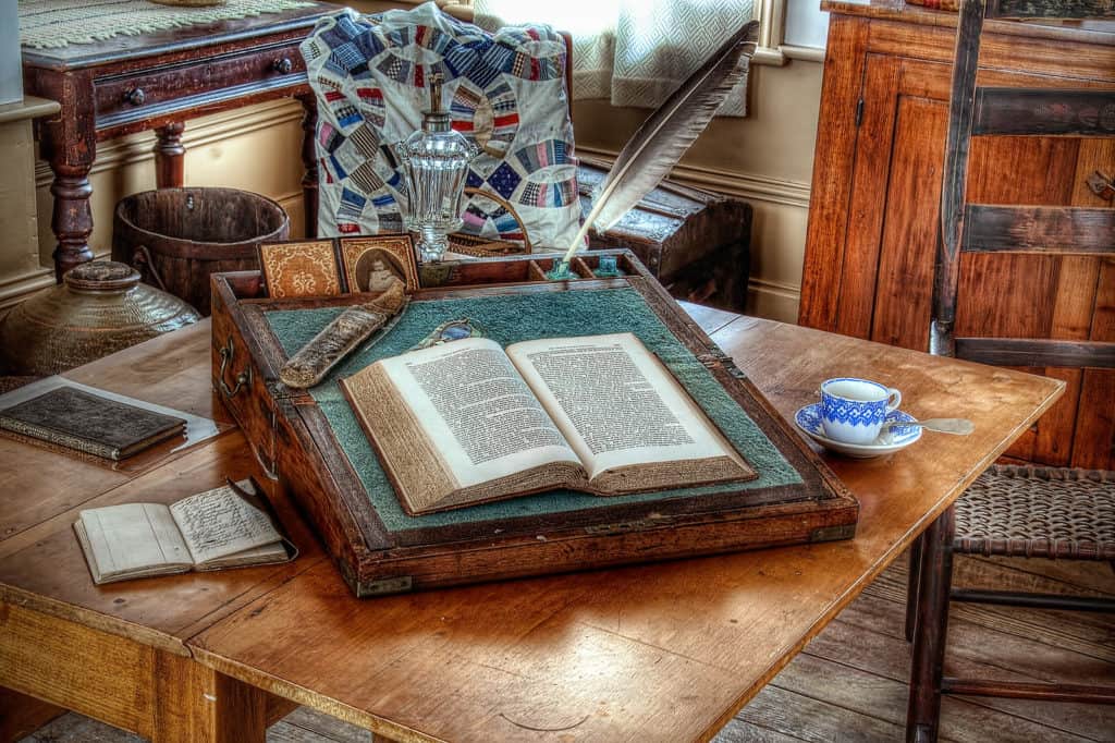 Open books and journals sit beside a tea cup an saucer in the historic Lee Home at the Willamette Valley Heritage Center.