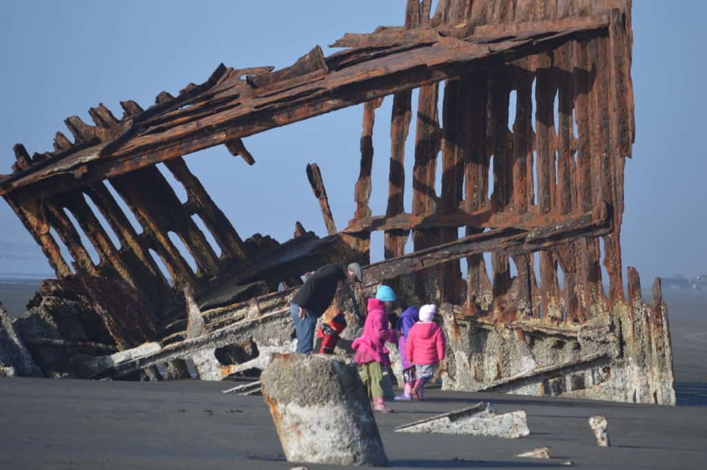 My children and I explore the massive remains the Peter Iredale. We're wearing winter gear to keep us warm on this winter excursion on the Oregon Coast.