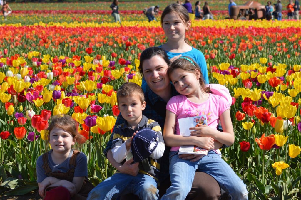 Family in front of the tulip field. Tulip festival Oregon best time to go.