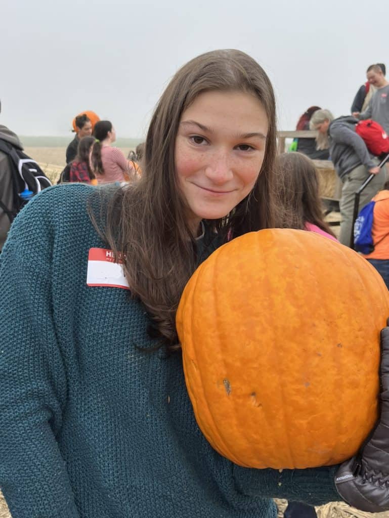 teen girl with a pumpkin