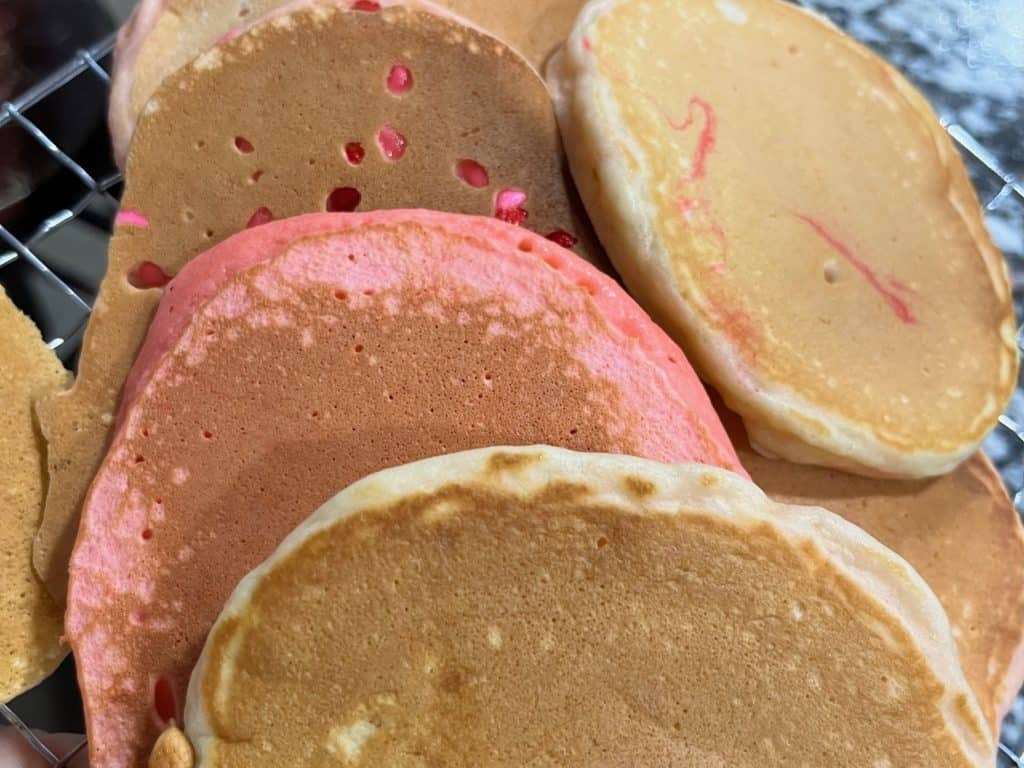 Pancakes with sprinkles, pink pancakes and plain pancakes. Valentine's Day breakfast ideas for kids.