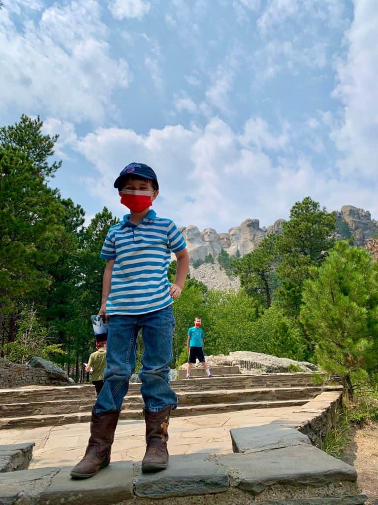My sons stand on a viewing platform at Mount Rushmore National Memorial.