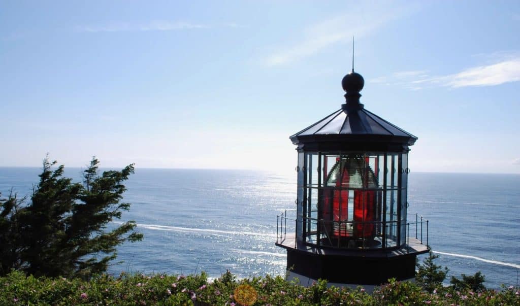 The top of Cape Meares Lighthouse looks over a wide expanse of ocean at Cape Meares State Scenic Viewpoint.