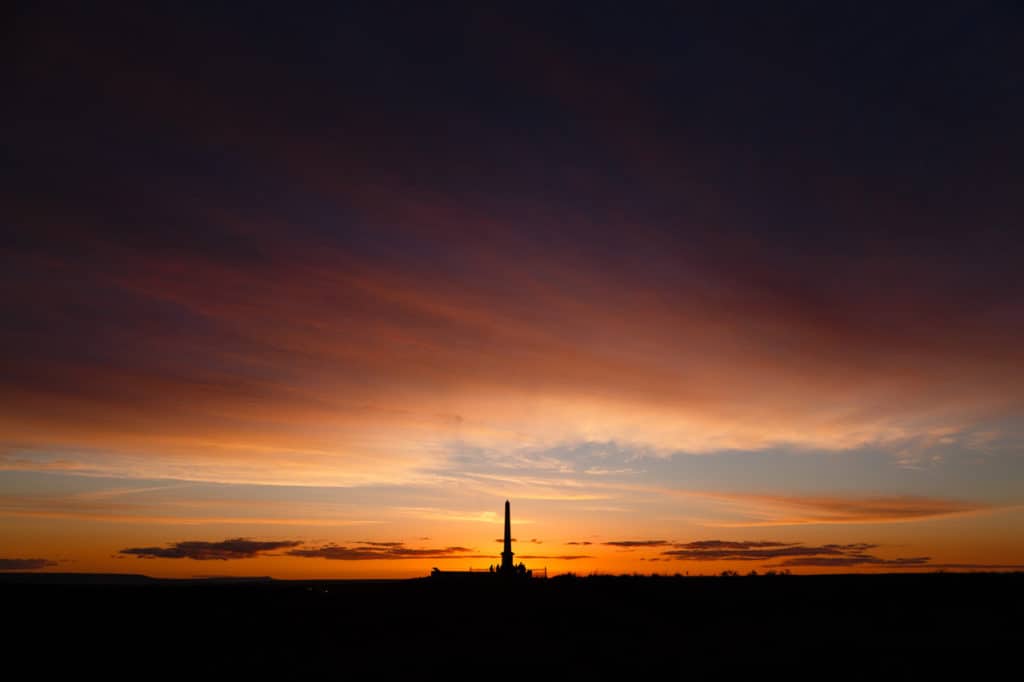 The Whitman Monument stands as an evening silhouette as the sun goes down in Eastern Washington.