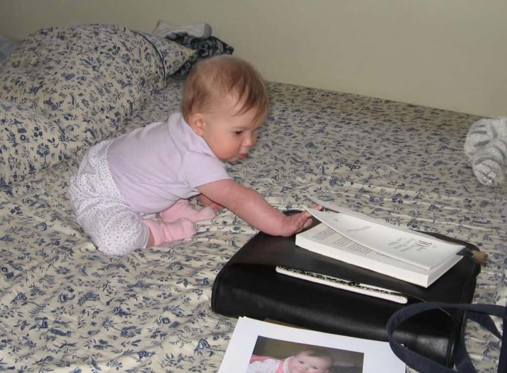 Our child grabs hold of a book that lays on top of my massive Franklin Covey planner. A Franklin Planner can be a good candidate as a best ADHD planner.