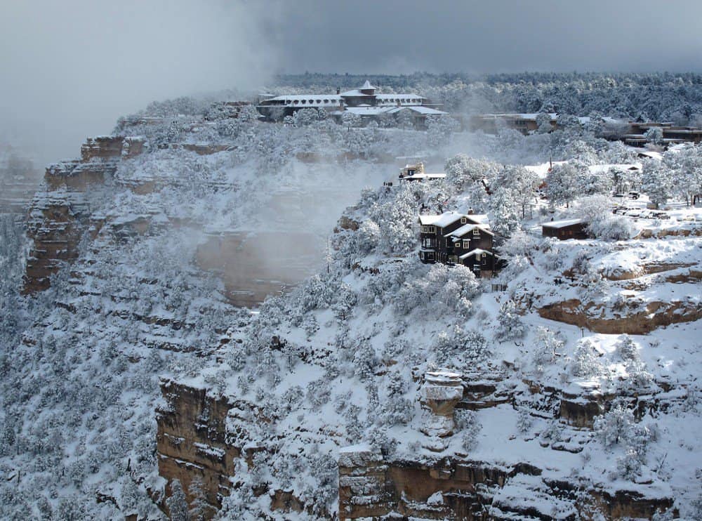 Snow covers the cliff faces and buildings along the south rim of the Grand Canyon. Grand Canyon National Park is one of the best national parks in November and December.