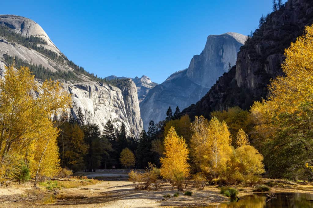 Gold leaves frame Yosemite's stern granite walls. Yosemite is one of the best national parks to visit in November and December.