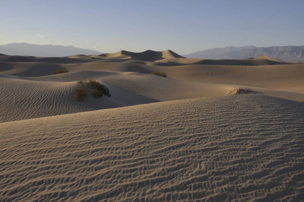 Dunes sit serenely at Death Valley National Park. Death Valley National Park is one of the best national parks to visit in November and December.