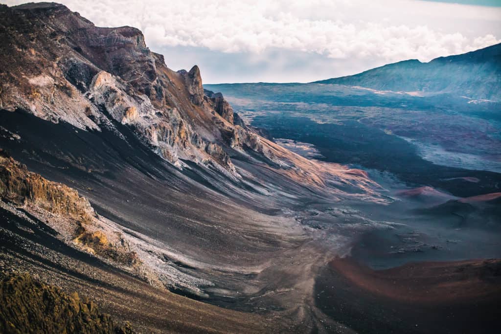 The martian-like landscape of Haleakala National Park spread out below. Haleakala National Park is one of the best national parks to visit in November and December.