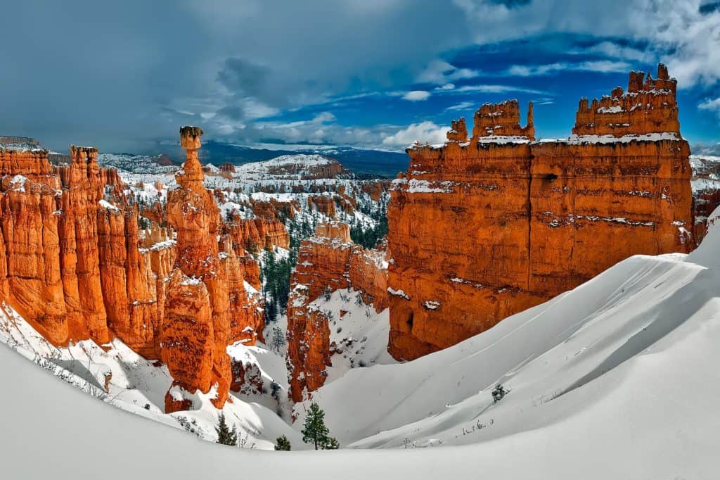 Blankets of snow surround, line, and top the hoodoos of Bryce Canyon National Park. Bryce Canyon National Park is one of the best national parks to visit in November and December.