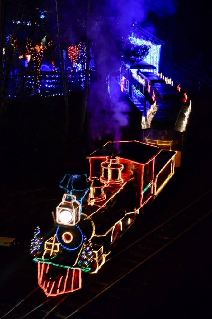 An illuminated train chugs along in ZooLights at the Oregon Zoo. ZooLights is an attraction that rivals the best Christmas lights in Salem Oregon.