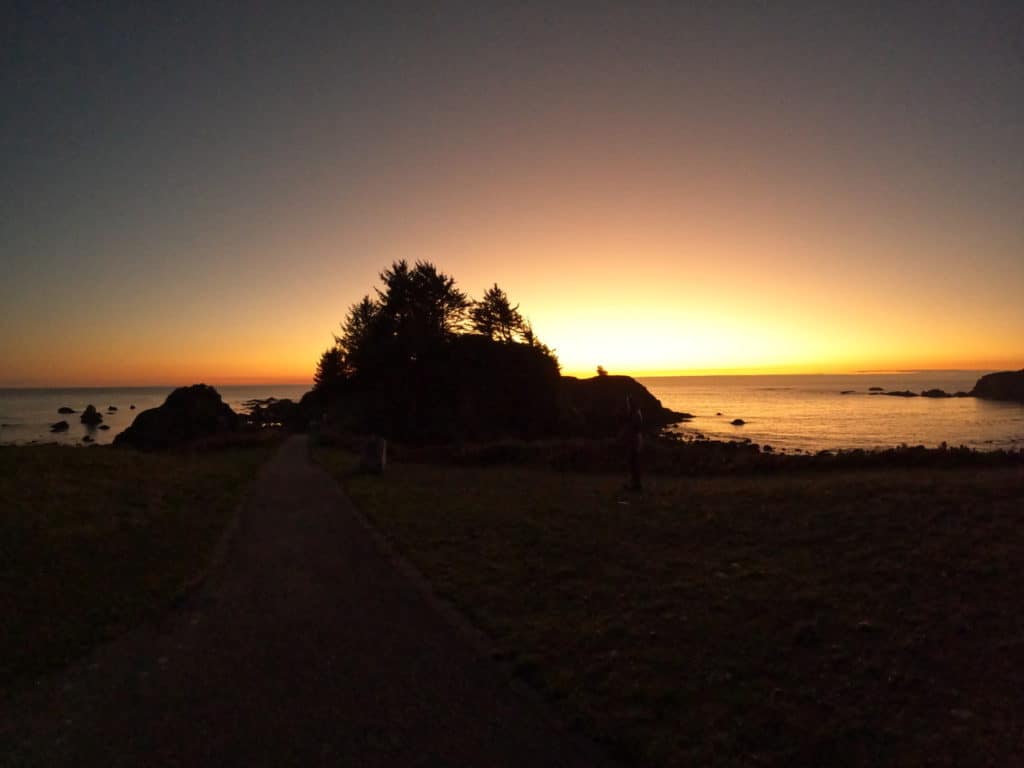 The sun sets behind Chetco Point on the Southern Oregon Coast.