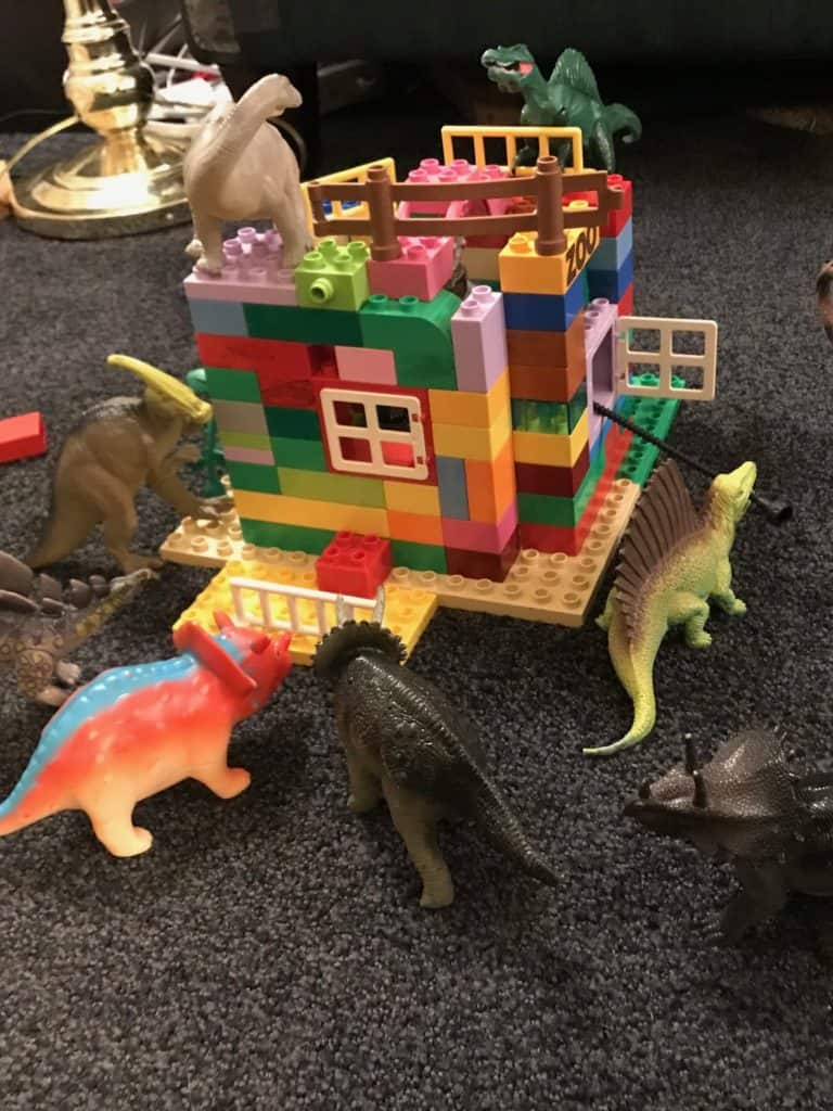 Dinosaur play figures on a Lego building. dinosaur gifts for a 5 year old