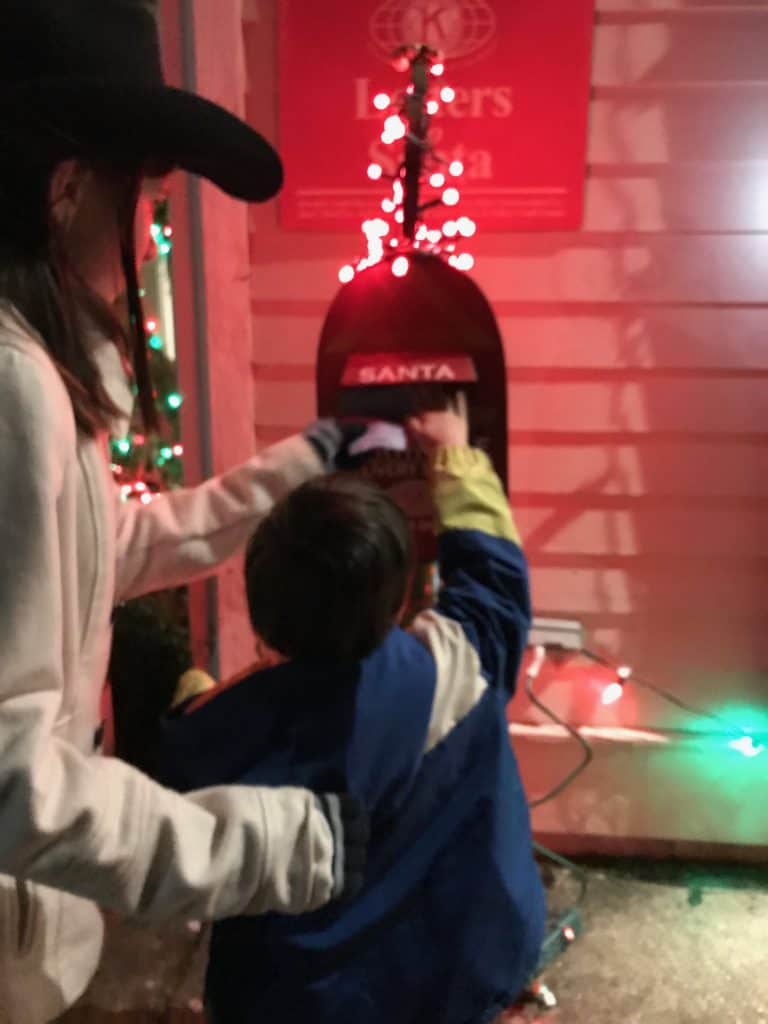 Boy and girl mailing a letter to Santa. Family Christmas bucket list.