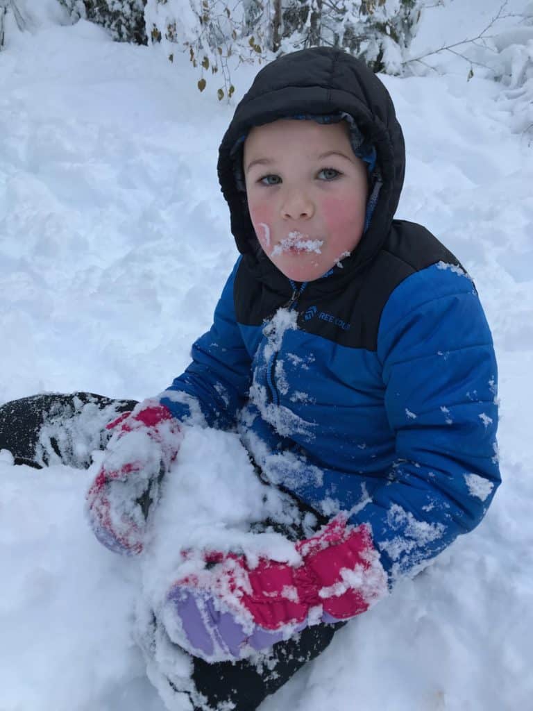 Boy eating snow. 