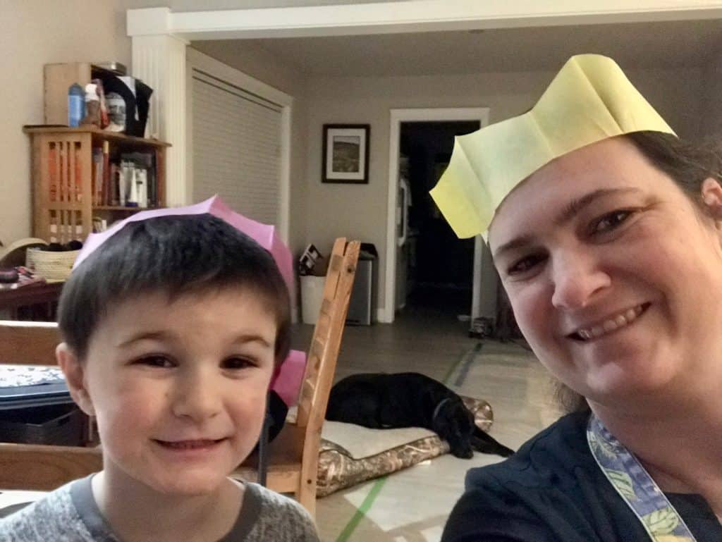 Mom and son wearing Christmas cracker paper crowns. Family Christmas bucket list.