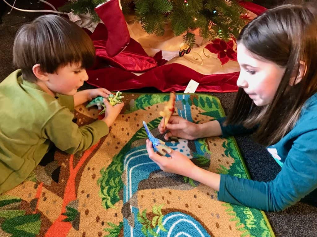 Kids playing on a dinosaur play mat. Dinosaur gifts for a 5 year old. 