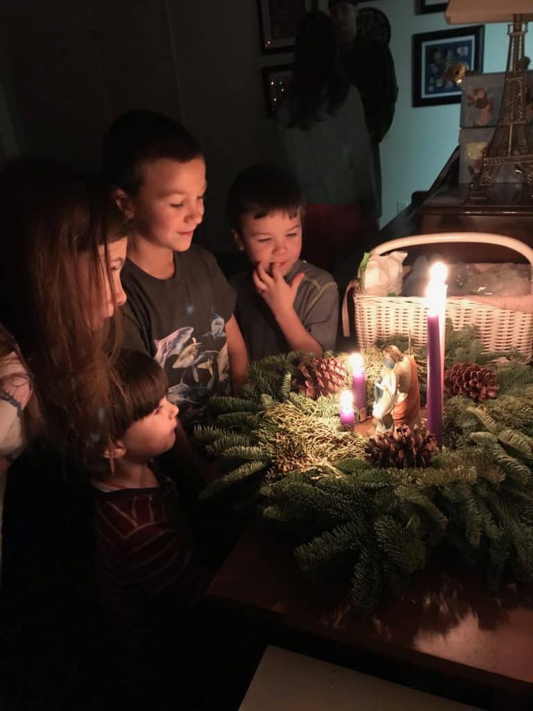 Children looking at advent wreath candles.