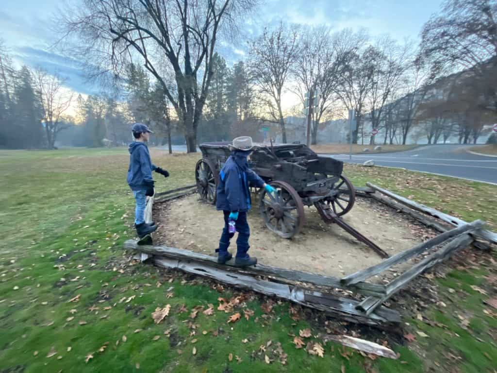My sons examine a historic cart at Valley of the Rogue State Park.