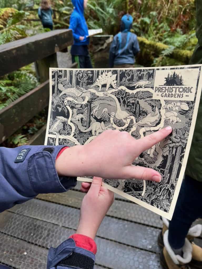 My son points out a dinosaur on his map provided by Prehistoric Gardens.