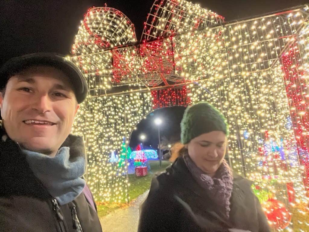 My wife and I pause for a selfie next to the enormous, illuminated present that serves as the entryway to the Riverfront Park lights display. Riverfront Park is one of the 11 best places to see Christmas lights in Salem Oregon.