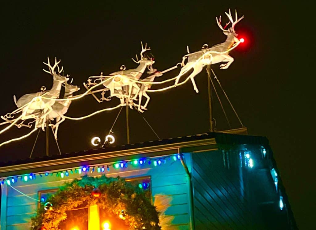 Rudolph and his fellow reindeer prance up off the roof of the Mortgage First Building. The Mortgage First lights display is one of the 11 best places to see Christmas lights in Salem Oregon.