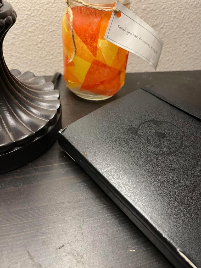 A used Panda Planner sits quietly on a black bed stand. Panda Planner is a good choice for the best ADHD planner.