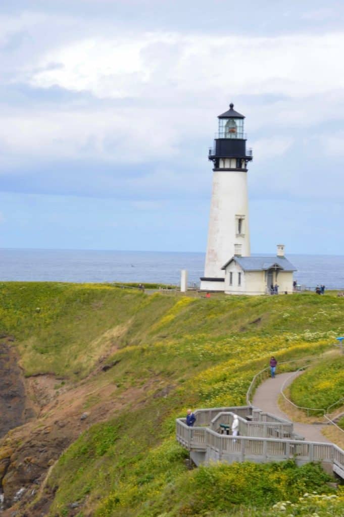 Yaquina Head Lighthouse stands tall in Yaquina Head Outstanding Natural Area. Yaquina Head of one of the best stops to make when touring the Oregon Coast with kids.