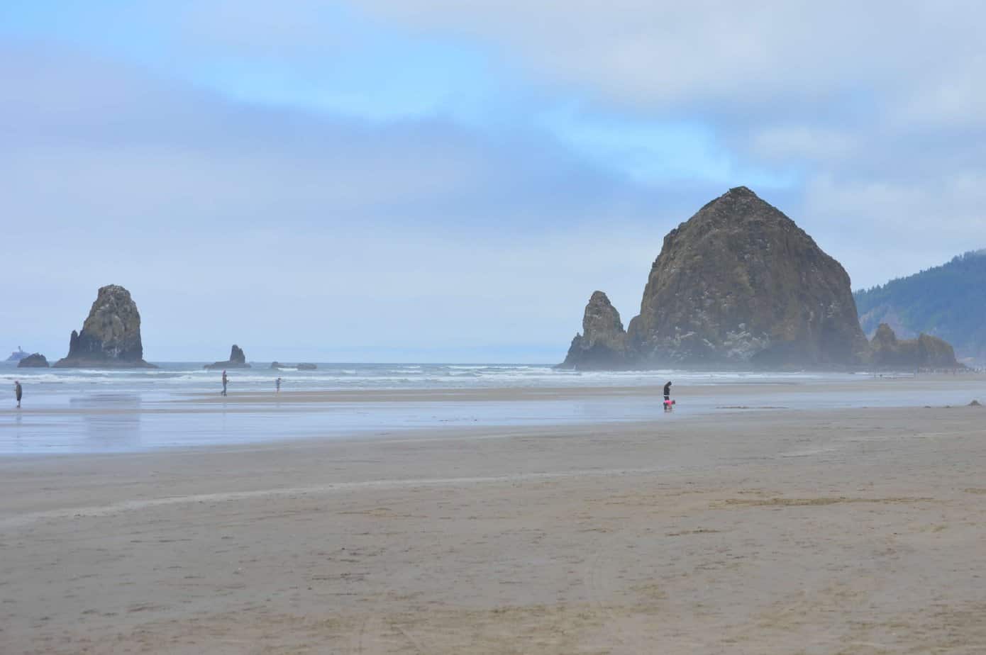 Haystack Rock and surrounding sea stacks stand majestically at Cannon Beach.