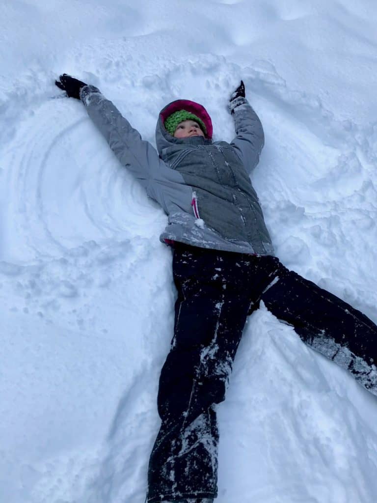 Girl making a snow angel. Winter Activities for Teens.