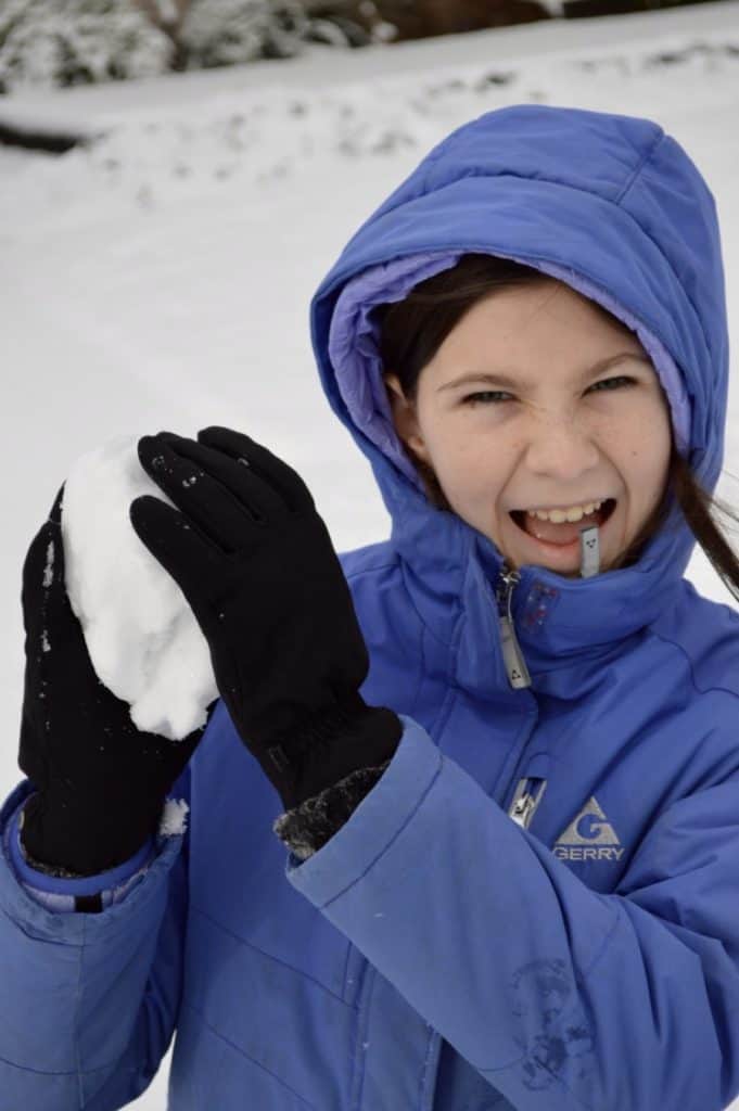 Girl ready to throw a snowball. Winter Activities for Teens.