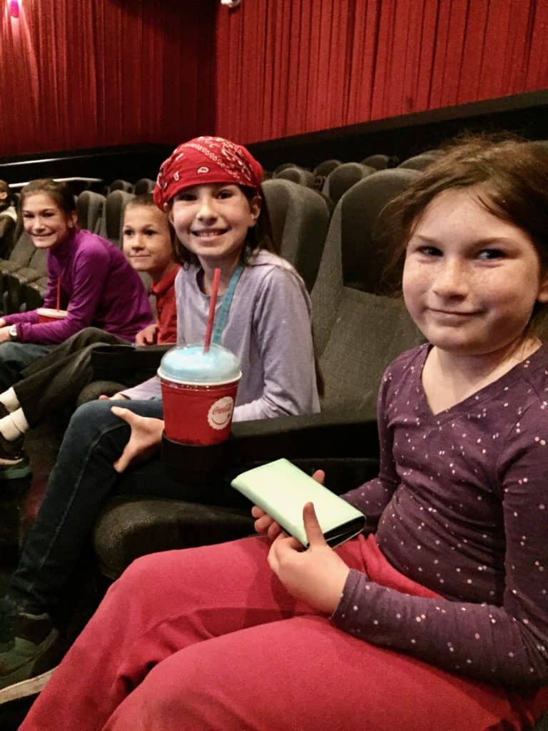 Kids at a movie theater. Winter activities for teens.
