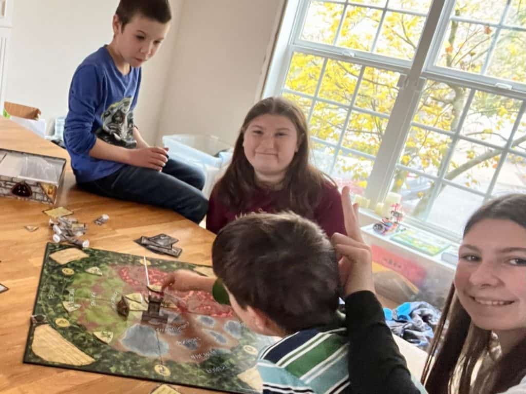 Kids playing a board game. Gifts for homeschool moms