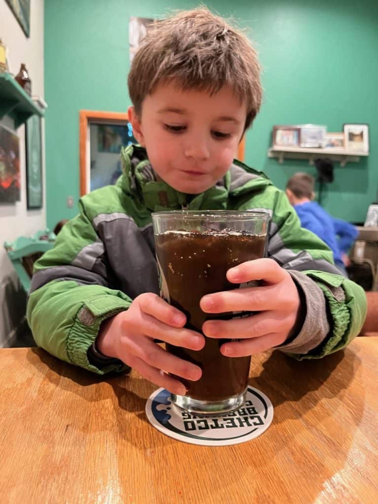 My son enjoys a tall glass of root beer at Chetco Brewing Company in Brookings Oregon.