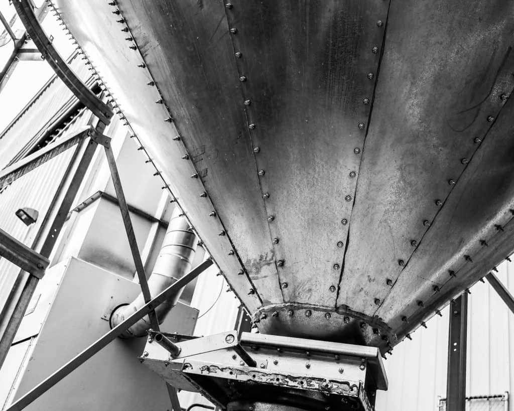 The black and white photo shows a fermenting tank at Ninkasi brewing.