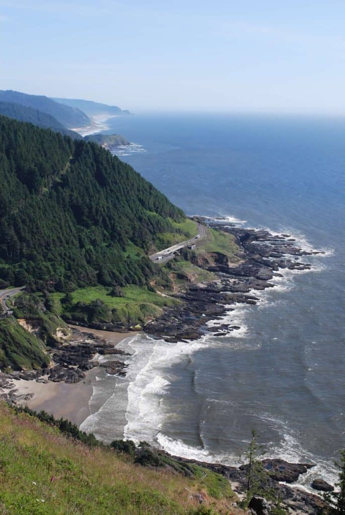 The viewpoint image shows a series of tall forested headlands that can be seen from Cape Perpetua. Cape Perpetua is a good, nature stop on a trip along the Oregon Coast with kids.