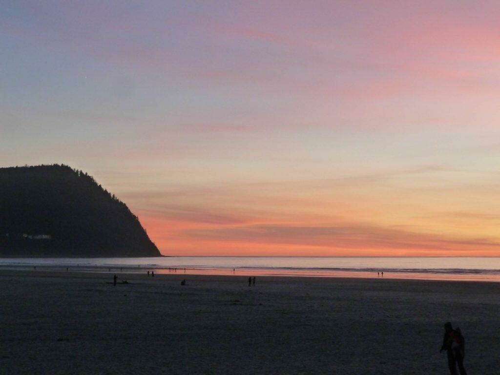 An evening sunset colors the horizon at Seaside Beach. The city of Seaside is an ideal destination when visiting the Oregon Coast with kids.