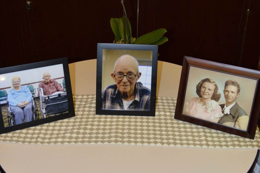 Table with old photos of author's grandparents. Our story of going No contact with toxic family.